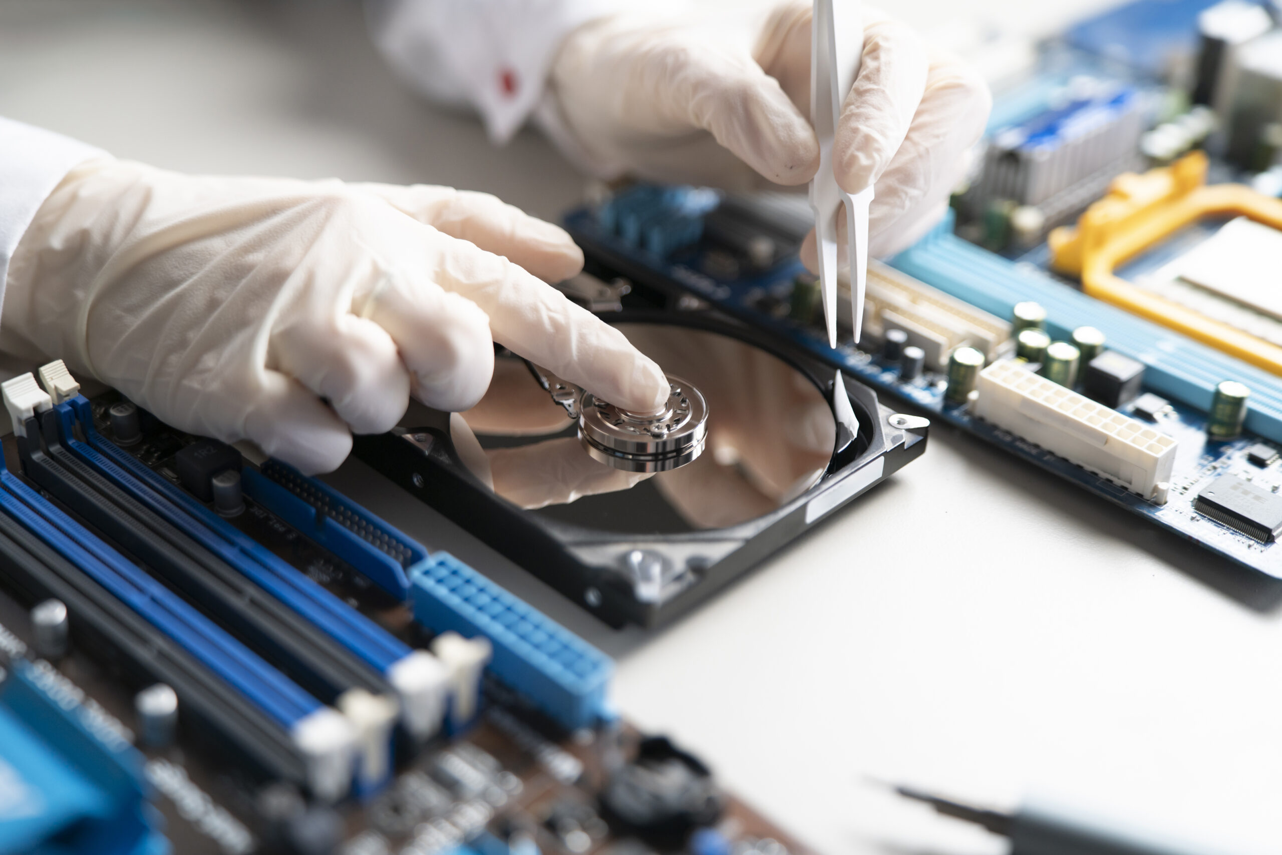 a person in gloves work in laboratory, repair broken hdd hard drive